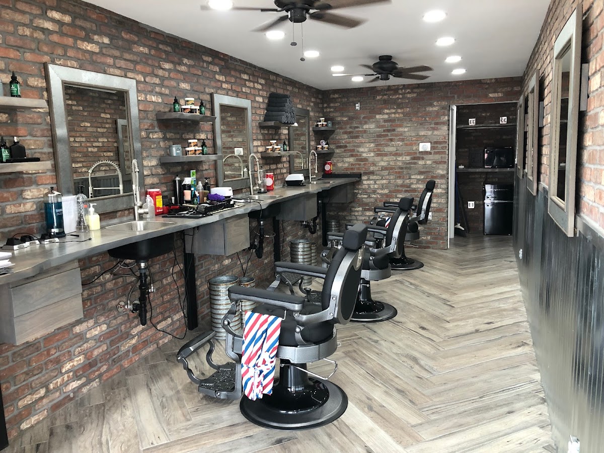 Bespoke Barber shop interior with exposed brick walls and classic barber chairs